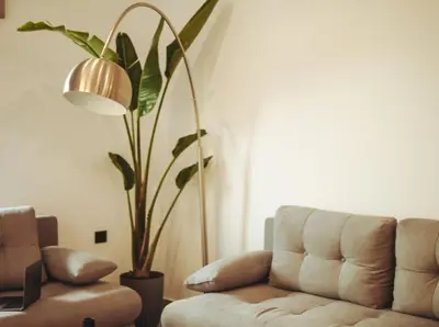 a living room with a couch and a potted plant at Villa Vriko in Agia Marina Nea Kydonias