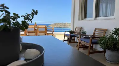 a dining room with a table and chairs and a view of the ocean at What a View Villa - Amazing Sea & Sunset Panorama with Pool in Chania Town