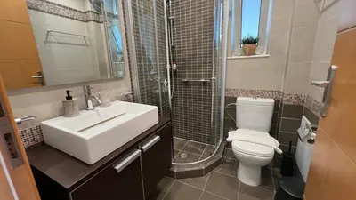a bathroom with a sink and a toilet and a shower at What a View Villa - Amazing Sea & Sunset Panorama with Pool in Chania Town