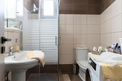 a bathroom with a toilet and a sink and a shower at Peggy's house by 8essentially in Chania Town