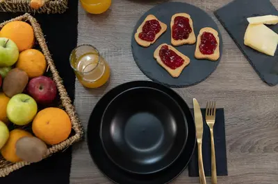 a table with a plate of bread with jam and fruit at Peggy's house by 8essentially in Chania Town