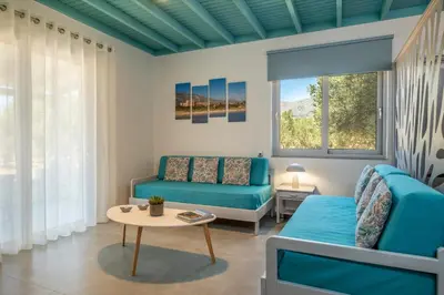 a living room with a couch and a table at Paradisos in Frangokastello