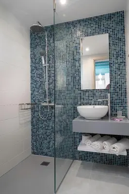 a bathroom with a glass shower and a sink at Paradisos in Frangokastello