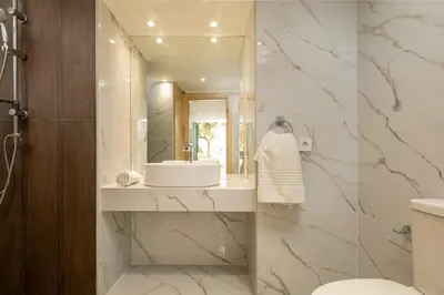 a bathroom with a sink and a mirror at Ydragogeio Rooms Old Town in Chania Town