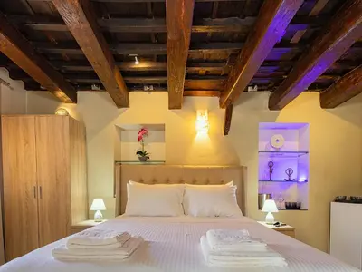 a bedroom with a bed with two towels on it at Ydragogeio Rooms Old Town in Chania Town