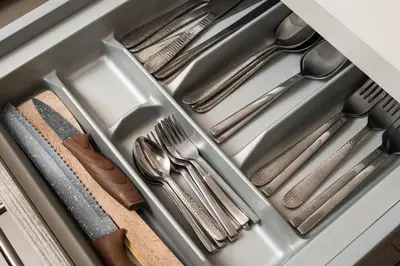 a drawer filled with silver utensils in a drawer at Luxury Apartment in Halepa in Chania Town