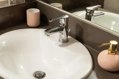 a white sink in a bathroom with a mirror at Luxury Apartment in Halepa in Chania Town