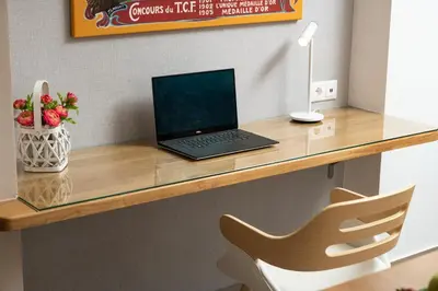 a laptop computer sitting on a desk with a chair at Luxury Apartment in Halepa in Chania Town