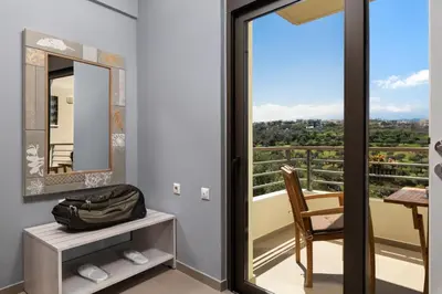 a room with a mirror and a bag on a table at Luxury Apartment in Halepa in Chania Town