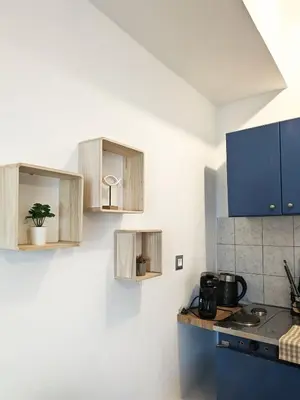 a kitchen with wooden cabinets and a counter top at Cozy Apartment in Chania Town