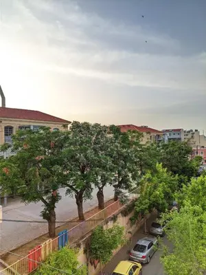 a view of a street with trees and cars at Cozy Apartment in Chania Town