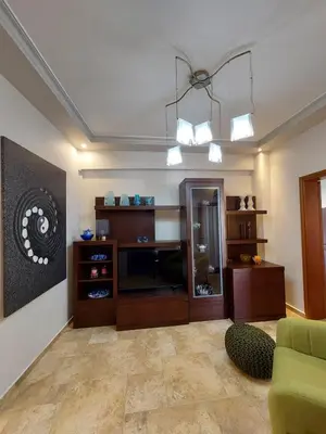 a living room with a couch and a chandelier at Rika's Sea View Apartment in Chania Town