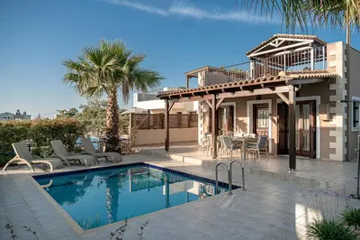 a villa with a swimming pool and a house at La Torre Villa in Palio Gerani