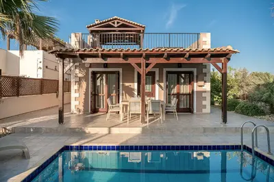a villa with a swimming pool and a house at La Torre Villa in Palio Gerani