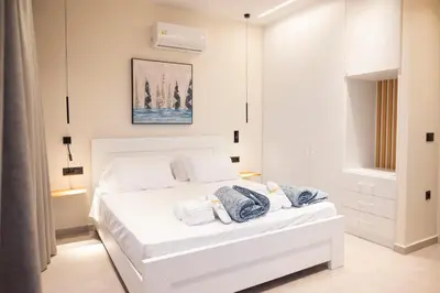 a white bedroom with a white bed in a room at Falasarna's Dream in Kissamos
