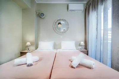 a bedroom with a large pink bed with two pillows at Gigis Apartment in Chania Town