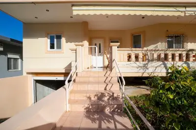 a house with stairs leading to the front porch at Gigis Apartment in Chania Town