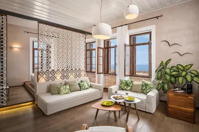 a living room with a couch and a table at Ambassadors Residence Boutique Hotel in Chania Town