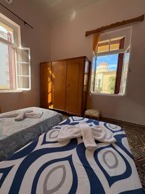 a bedroom with two beds with towels on them at THE NEOCLASSICAL Garden House in Chania Town