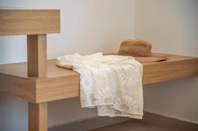 a hat and towels on a wooden shelf at Onar Villa - staying in comfort in Kissamos