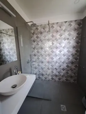 a bathroom with a sink and a shower at Artemis Apartments in Kalyves