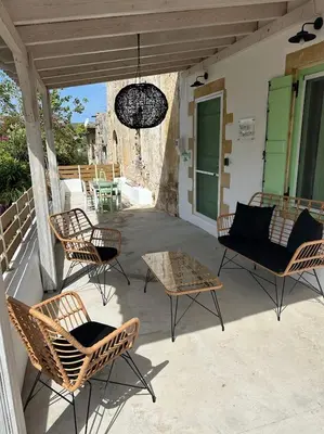 a group of chairs and a table on a patio at NiMa Maison in Kissamos