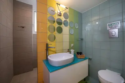 a bathroom with a sink and a toilet at Meraki Cretan Hospitality in Maleme