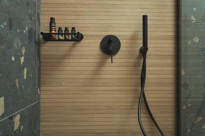 a wall with a shower with bottles on it at Limani elegant apartments in Souda