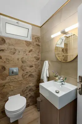 a bathroom with a white sink and a toilet at 3 bedroom apt in Nea Chora 400 meters walk to the beach in Chania Town