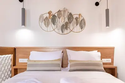 a bedroom with a bed with two pillows at Casa Nicola's in Chania Town