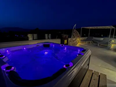a jacuzzi tub with purple lights on a roof at Luxury Dream with Private Jacuzzi in Kaloudhianá