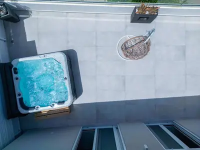 a swimming pool with a basket on a wall at Luxury Dream with Private Jacuzzi in Kaloudhianá