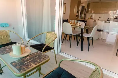 a living room with a table and chairs and a kitchen at G&M Luxury Residence with pool in Chania Town