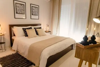 a bedroom with a large bed and a window at G&M Luxury Residence with pool in Chania Town