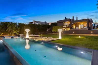 a swimming pool in front of a house at Chania lux villa with Heated pool in Chania Town