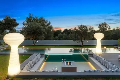 a swimming pool with two lights in a yard at Chania lux villa with Heated pool in Chania Town