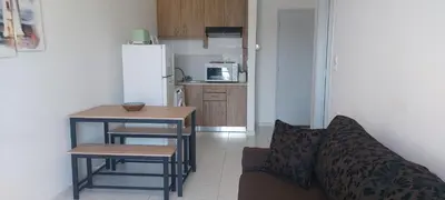 a living room with a couch and a table and a kitchen at Sun Beach Apartments in Chania 8 &10& 13 in Chania Town