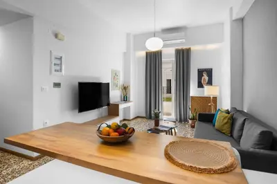 a living room with a bowl of fruit on a table at Apartment Arancione in Chania Town