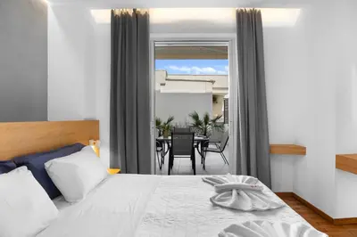 a bedroom with a bed and a dining room at Apartment Arancione in Chania Town