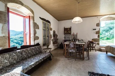 a living room with a couch and a table at Tsikalaria Traditional Stone House in Tsikalariá