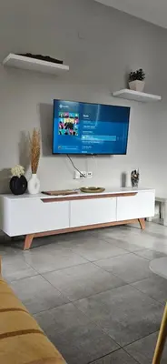 a living room with a tv on a white wall at heaven suite elafonisi in Elafonisi