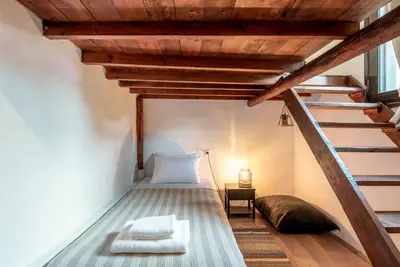 a bedroom with a bed and a stair case at Joel Living Collection - Rustic Villa in Áptera