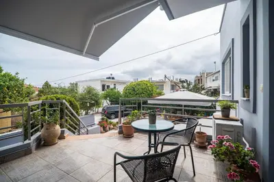 a patio with a table and chairs on a balcony at ''Meraviglia'' casa ''Nefeli'' in Chania Town