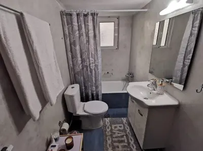 a bathroom with a toilet and a sink and a mirror at Comfy APT in Chania City Center in Chania Town