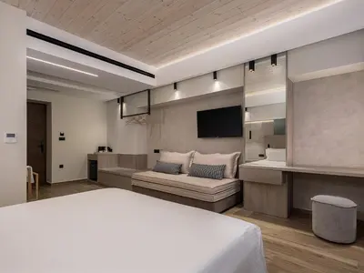 a hotel room with a bed and a tv at Casa Dorini in Chania Town