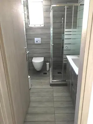 a bathroom with a shower and a toilet and a sink at Pegasus Amazing Flat, 1,5min Walk To The Beach in Chania Town