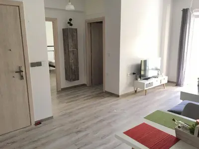 a living room with white walls and wooden floors at Pegasus Amazing Flat, 1,5min Walk To The Beach in Chania Town