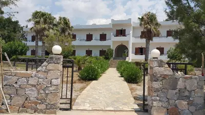 a building with a gate and a stone wall at Studios Stavris in Frangokastello
