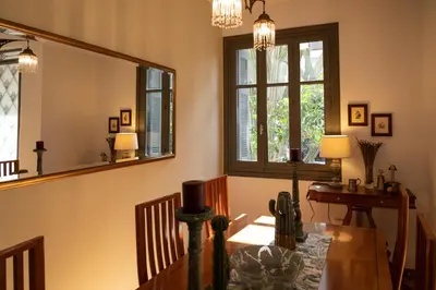 a dining room with a table and a mirror at Cactus Residence Chania in Chania Town