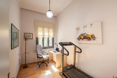 a room with a treadmill and a desk with a chair at Cactus Residence Chania in Chania Town